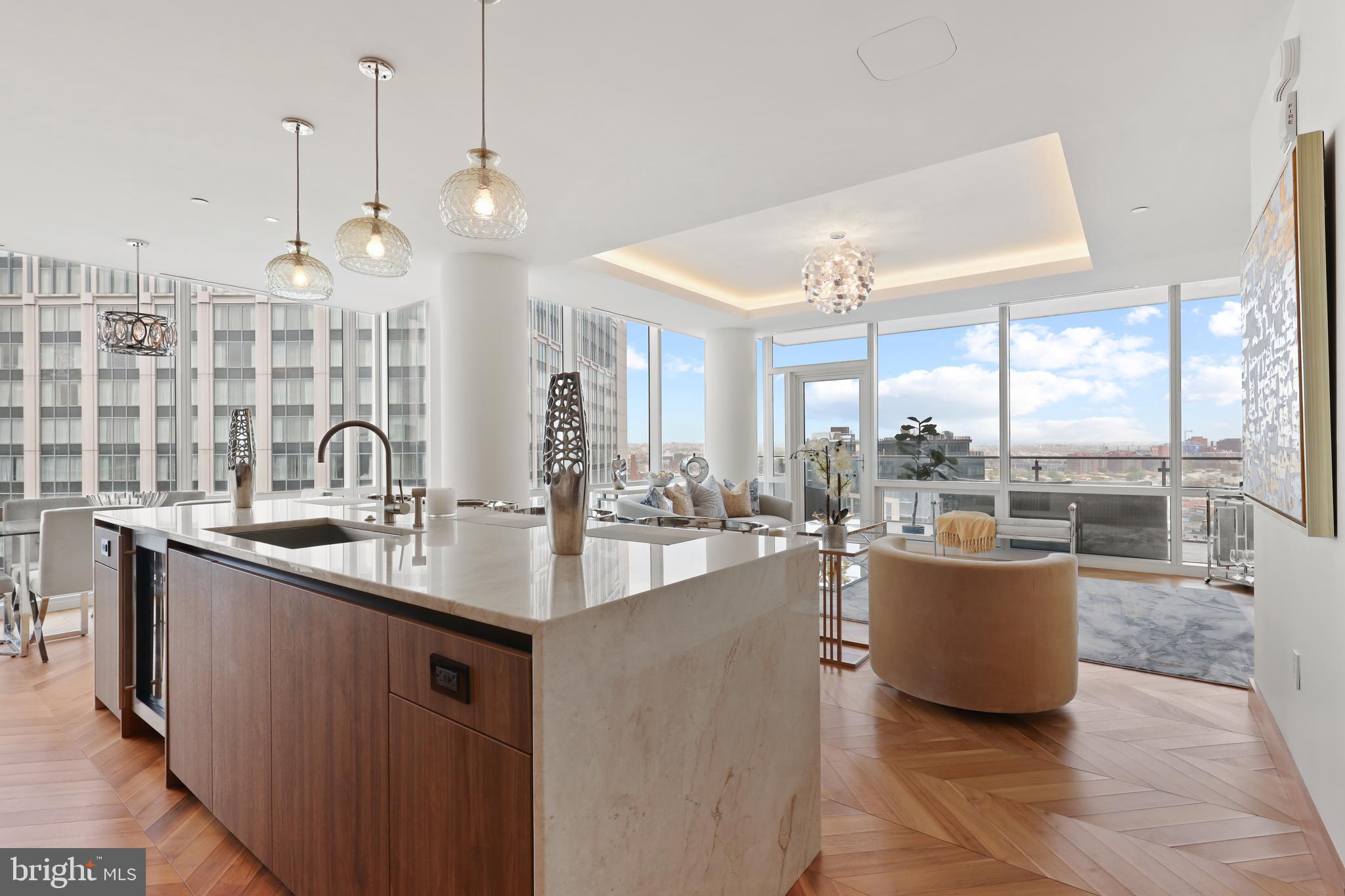 300 International Drive, Unit 2403 Baltimore, MD 21202 - Photo 10 of 36 a kitchen with sink and living room view