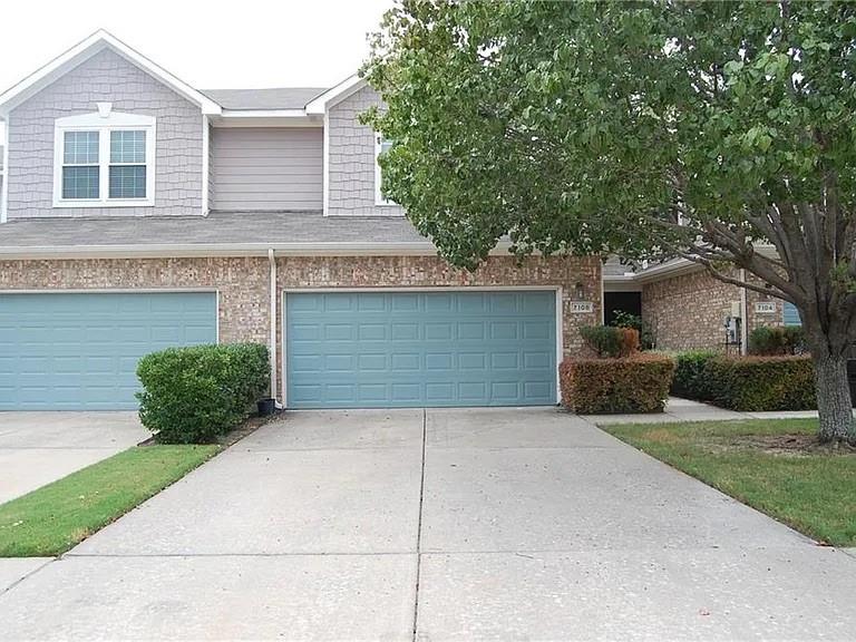 7108 Wolfmont Lane Plano, TX 75025 - Photo 1 of 1 a front view of a house with a yard and garage