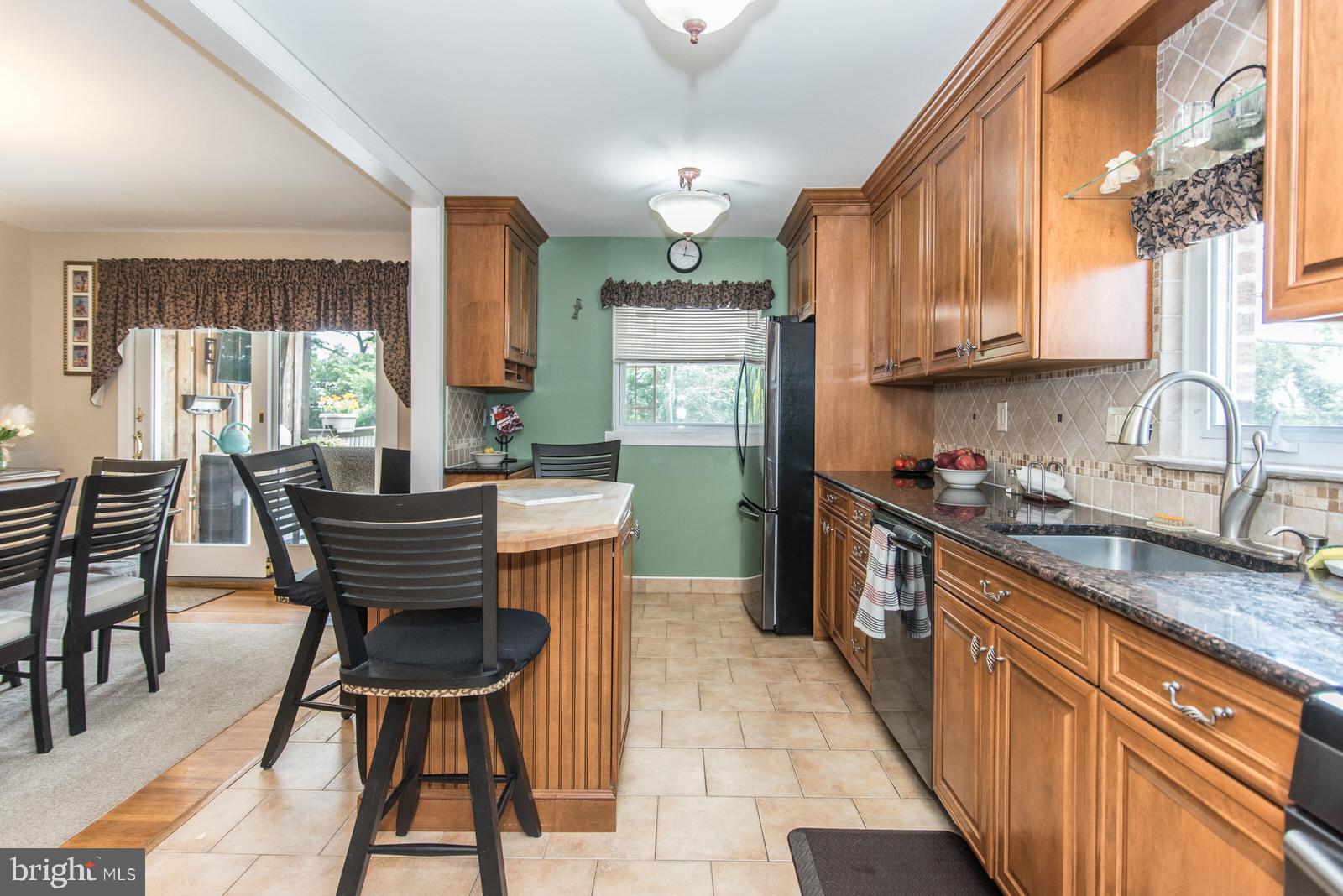 1216 Jennifer Road Philadelphia, PA 19116 - Photo 23 of 77 a kitchen with a sink dining table and chairs