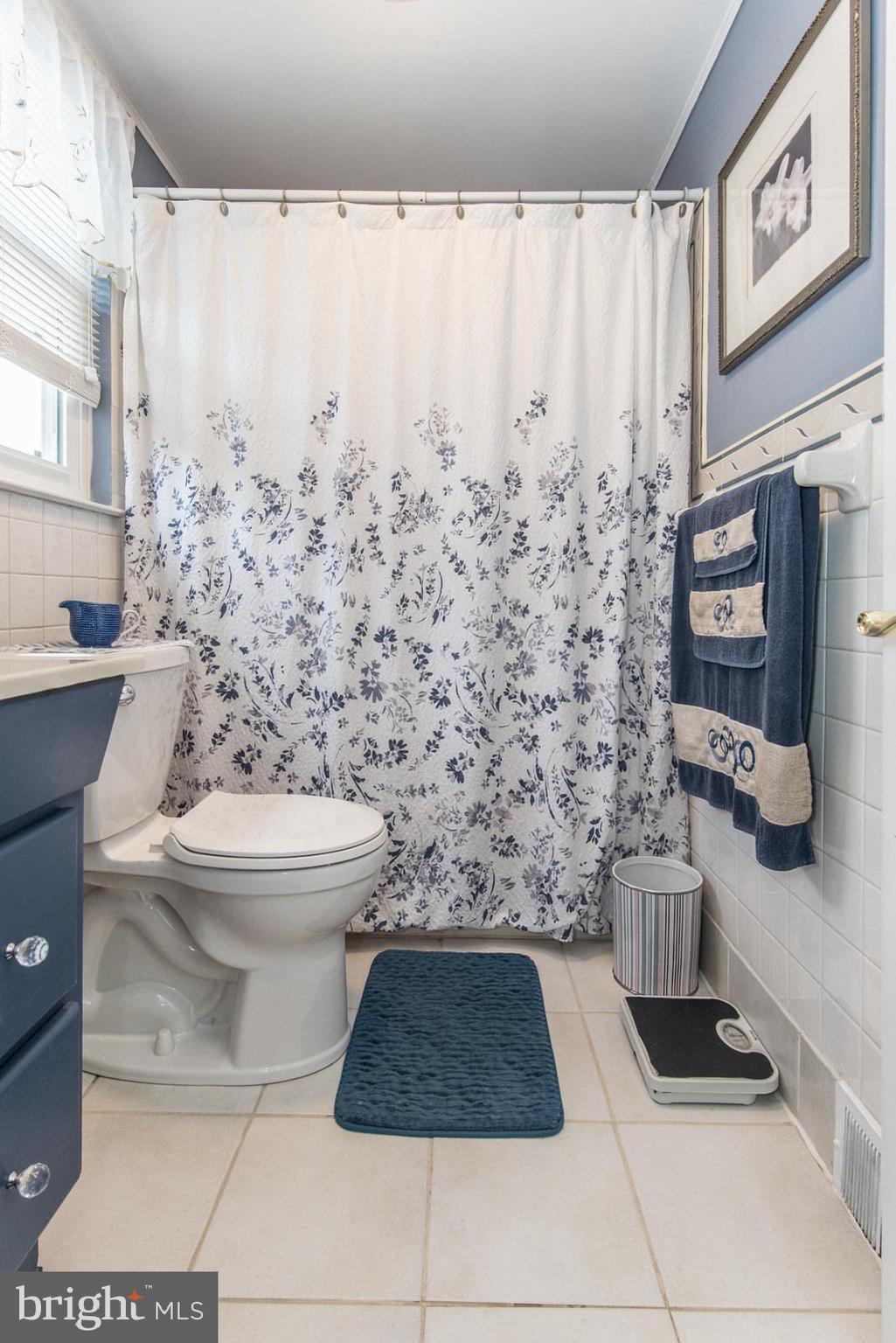 1216 Jennifer Road Philadelphia, PA 19116 - Photo 44 of 77 a bathroom with a toilet and a shower curtain