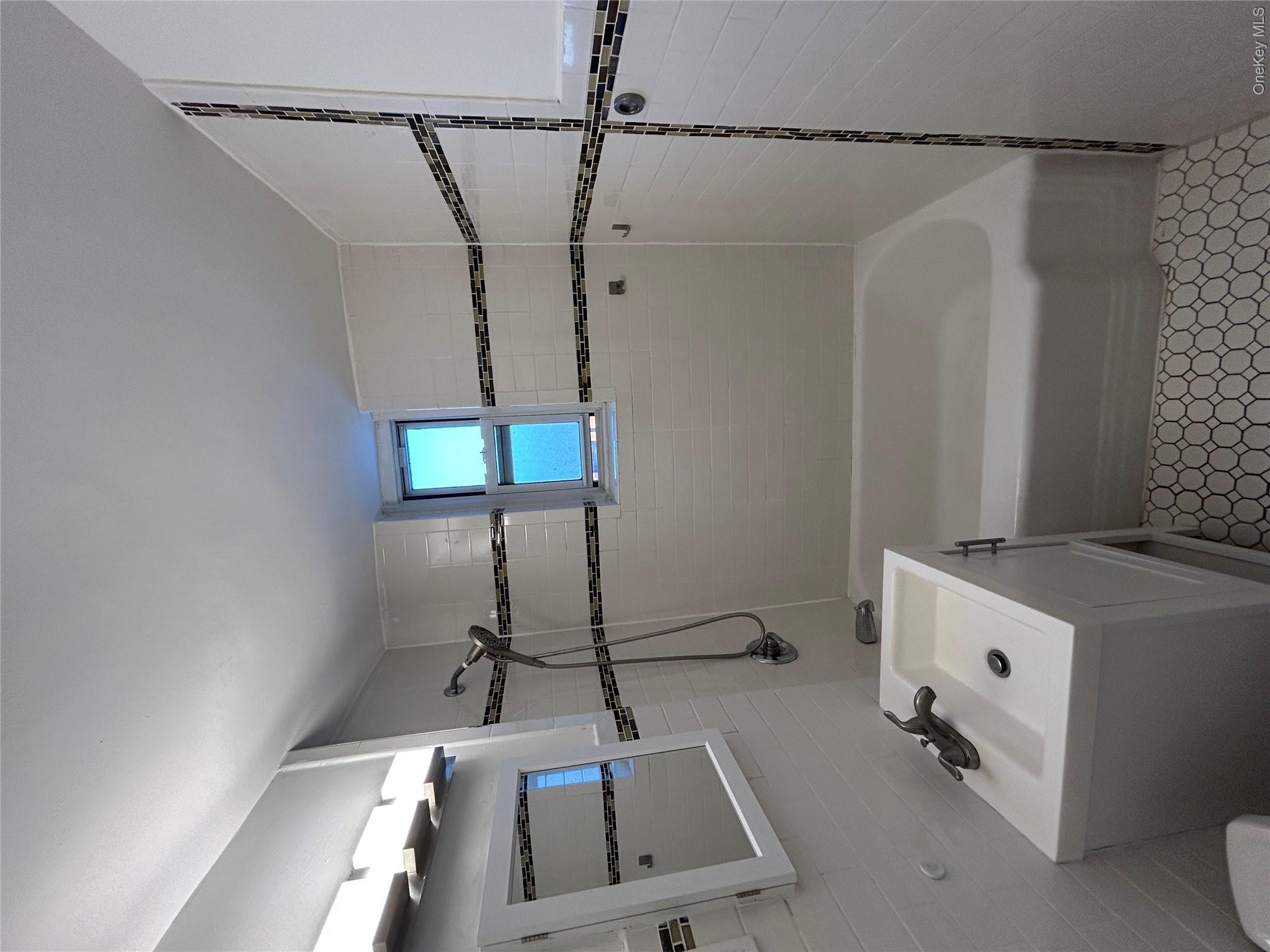 210 Pelham Road, Unit 5P New Rochelle, NY 10805 - Photo 11 of 25 a bathroom with a sink a bath tub and a shower
