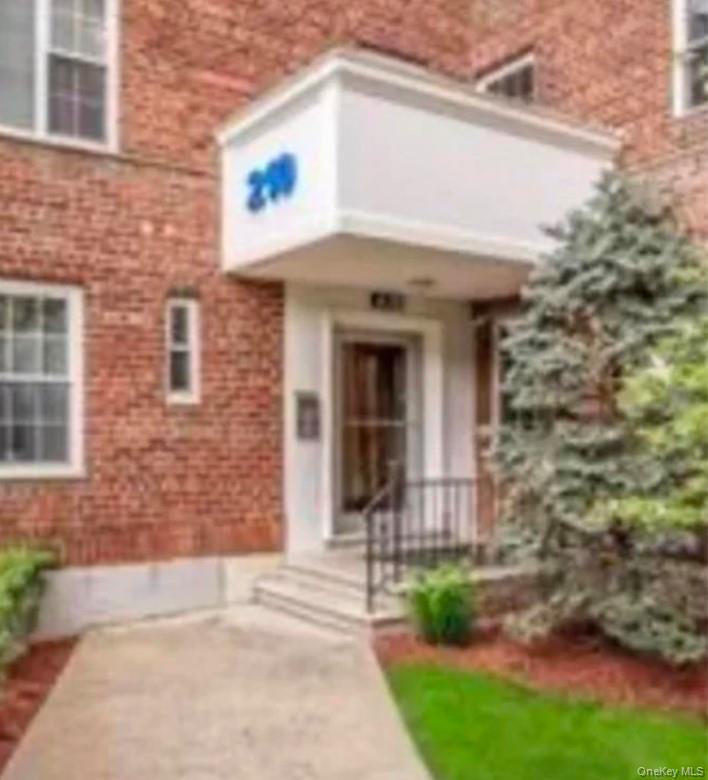 210 Pelham Road, Unit 5P New Rochelle, NY 10805 - Photo 20 of 25 a front view of a house with a garden