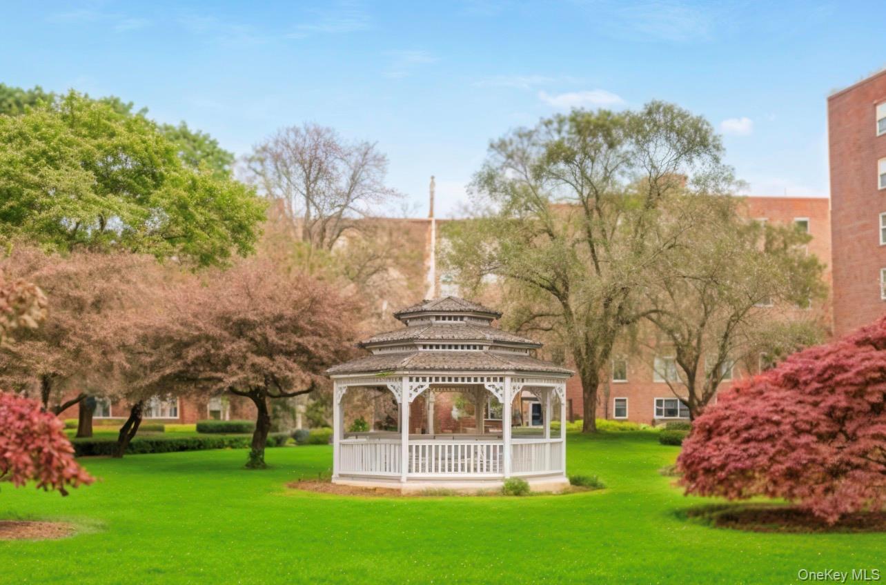 210 Pelham Road, Unit 5P New Rochelle, NY 10805 - Photo 23 of 25 a view of a big building with a big yard and large trees