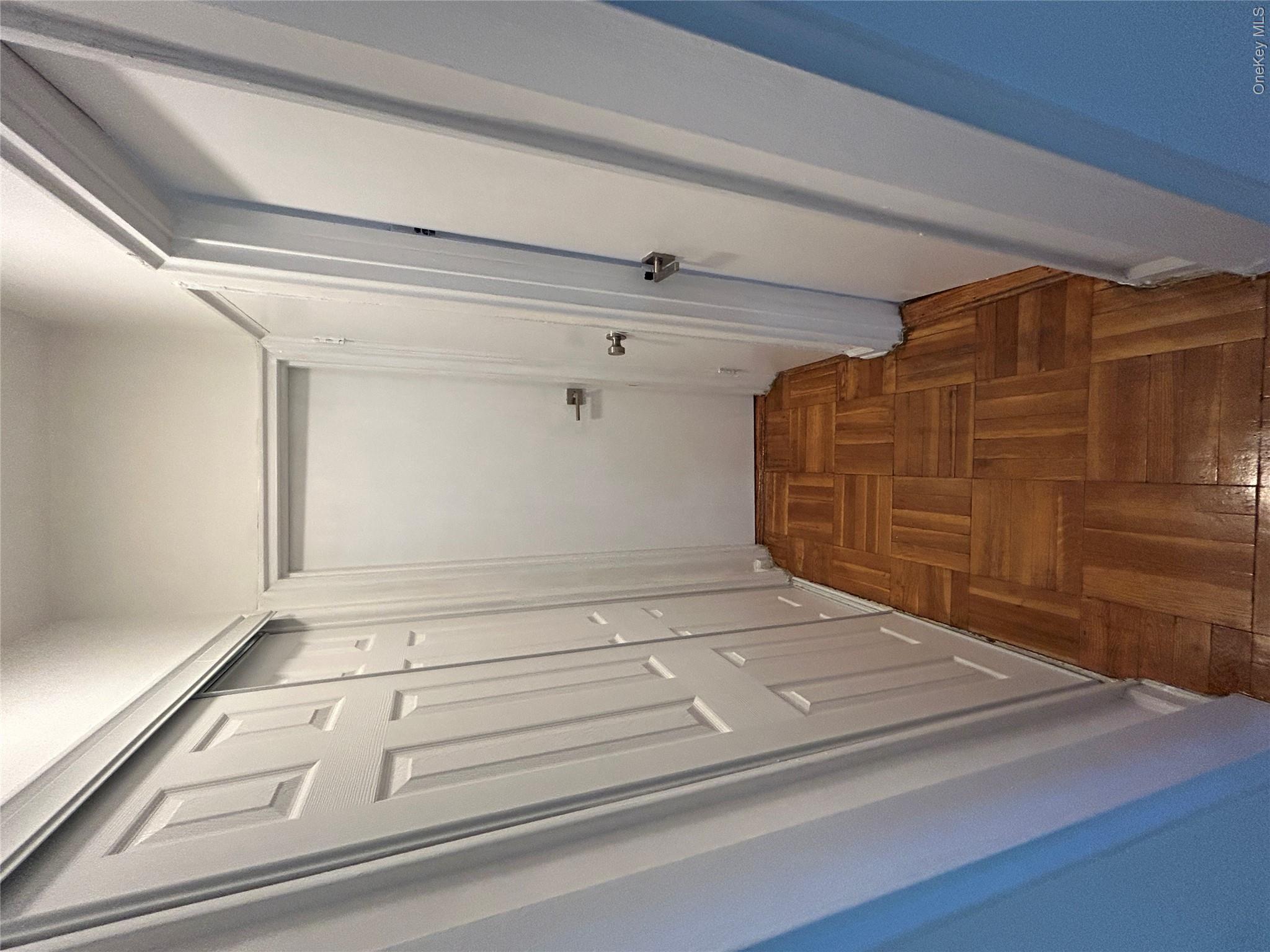 210 Pelham Road, Unit 5P New Rochelle, NY 10805 - Photo 5 of 25 a view of a hallway with wooden floor and staircase