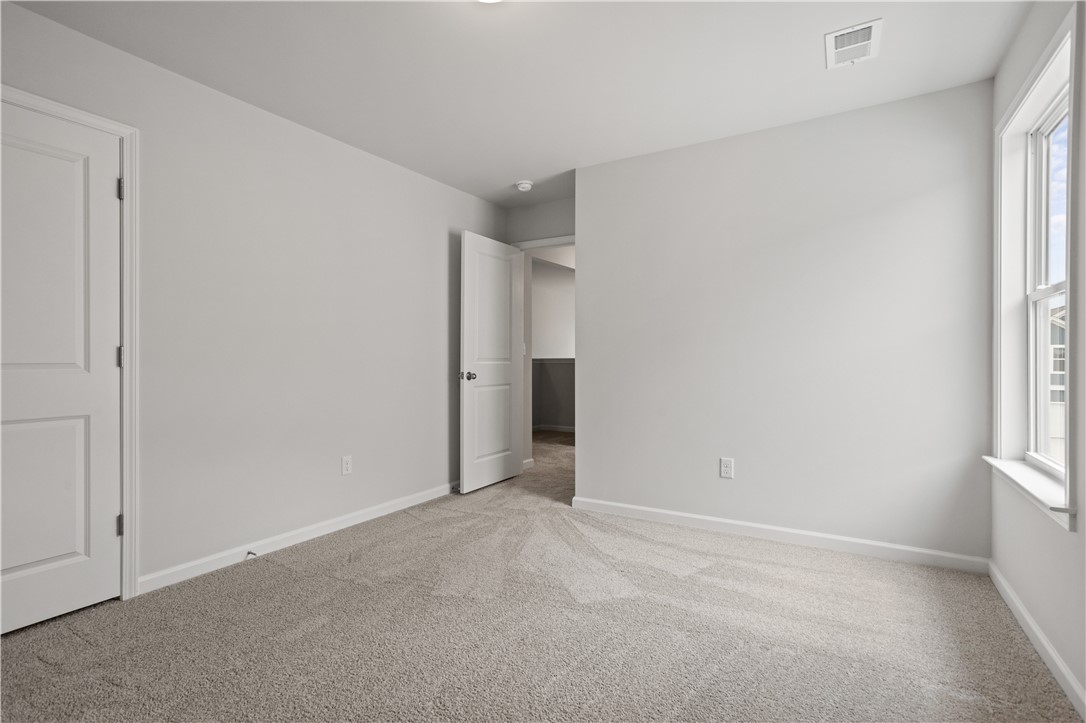 555 Hydrangea Street, Unit LOT 47 Seneca, SC 29678 - Photo 31 of 38 A well-lit bedroom provides ample natural light and a neutral canvas.