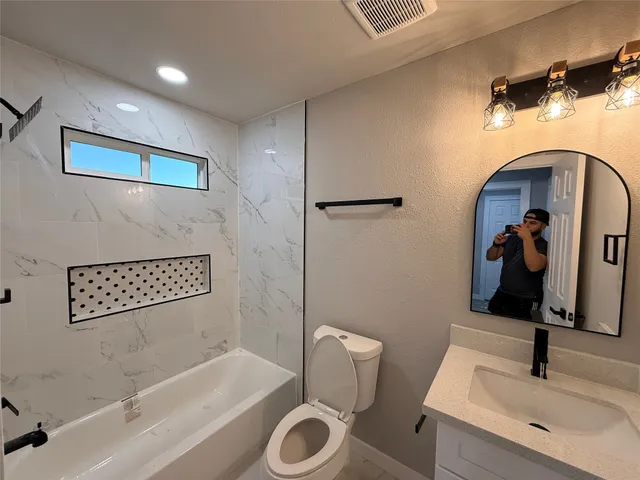 a bathroom with a sink a toilet and a bathtub