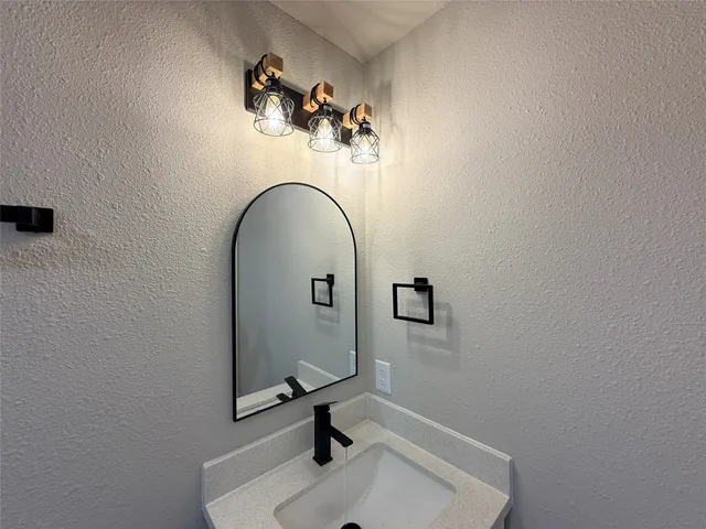 a bathroom with a sink and mirror