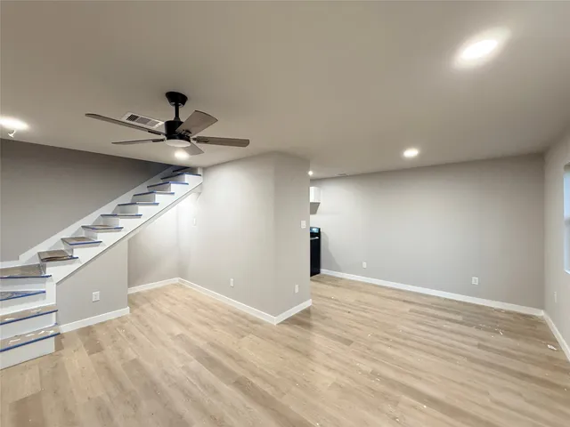 a view of a ceiling fan and wooden floor