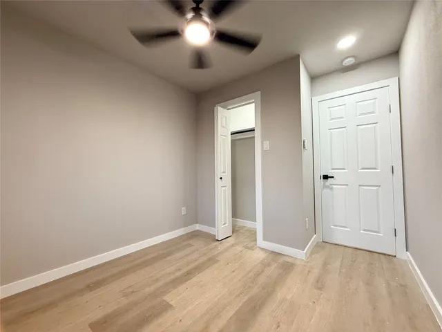 an empty room with a empty space and a ceiling fan