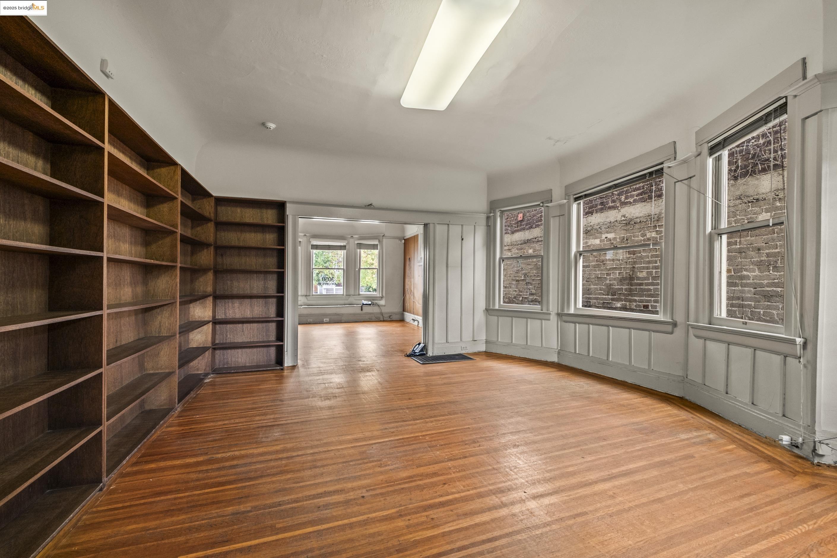 3050 Shattuck Avenue Berkeley, CA 94705 - Photo 11 of 41 a view of an empty room with wooden floor and a window