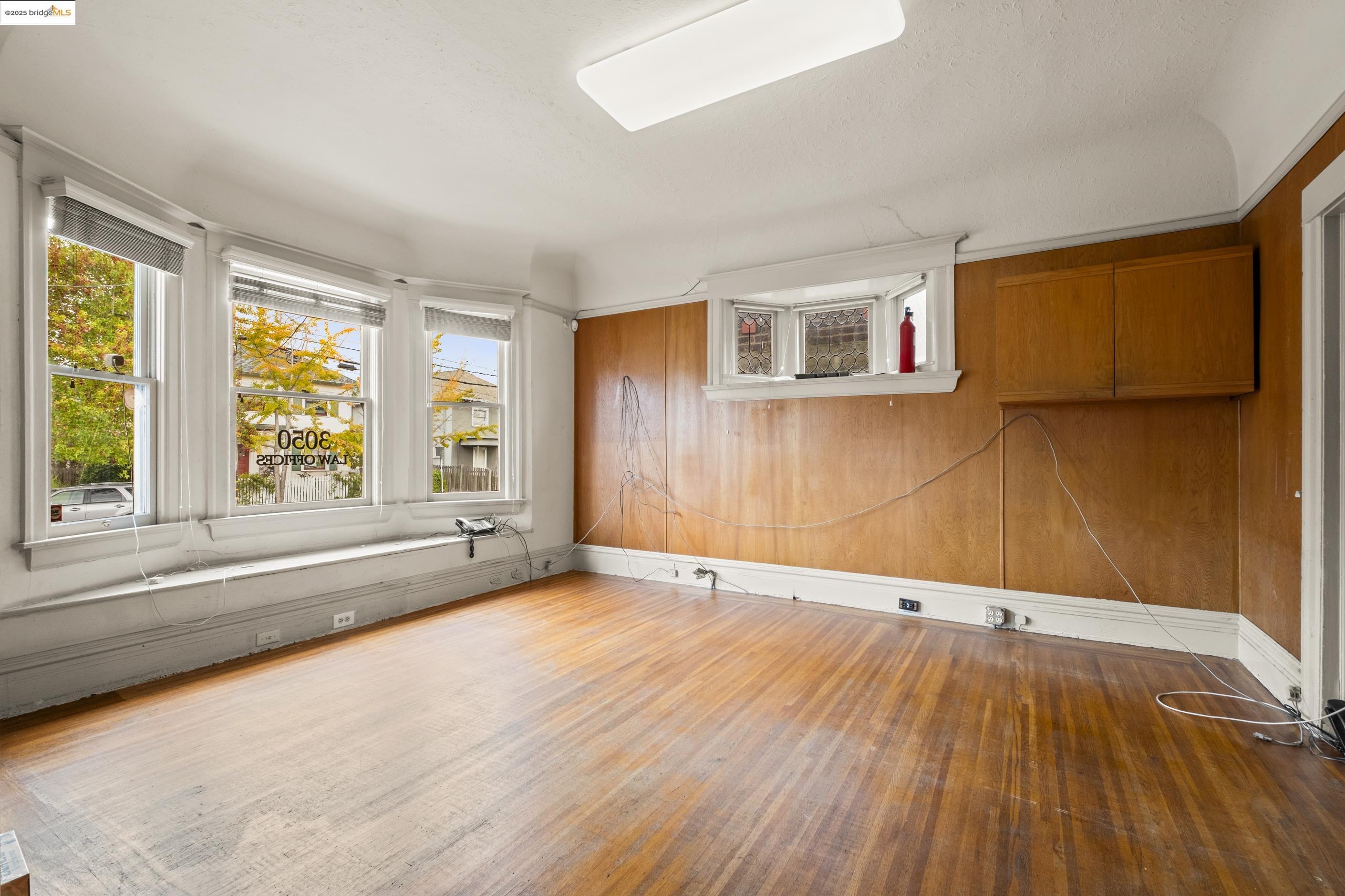 3050 Shattuck Avenue Berkeley, CA 94705 - Photo 16 of 41 a view of an empty room with wooden floor and a window