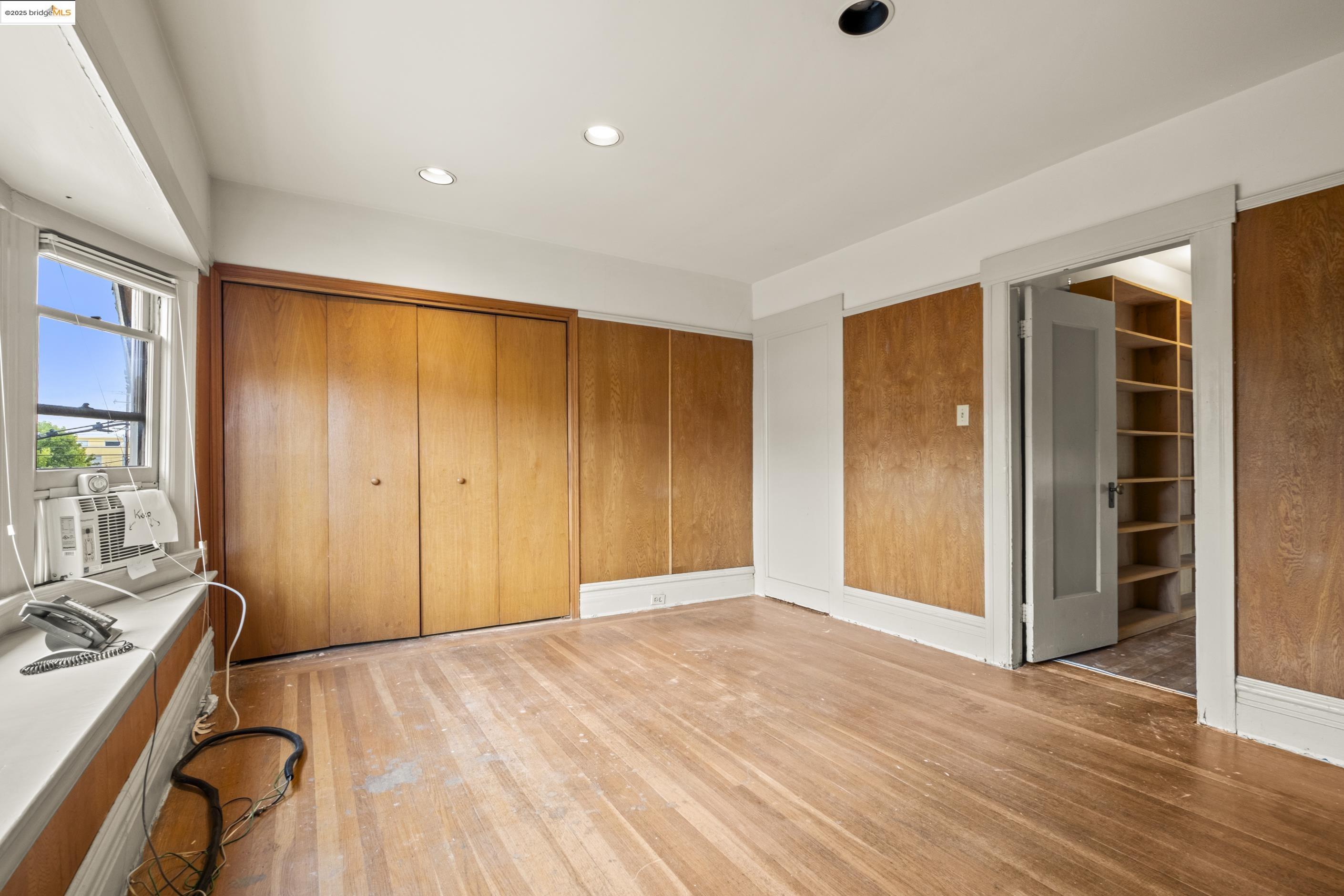 3050 Shattuck Avenue Berkeley, CA 94705 - Photo 20 of 41 an empty room with wooden floor and windows