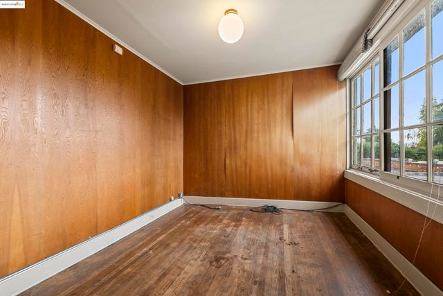 a view of a room with wooden floor and a window