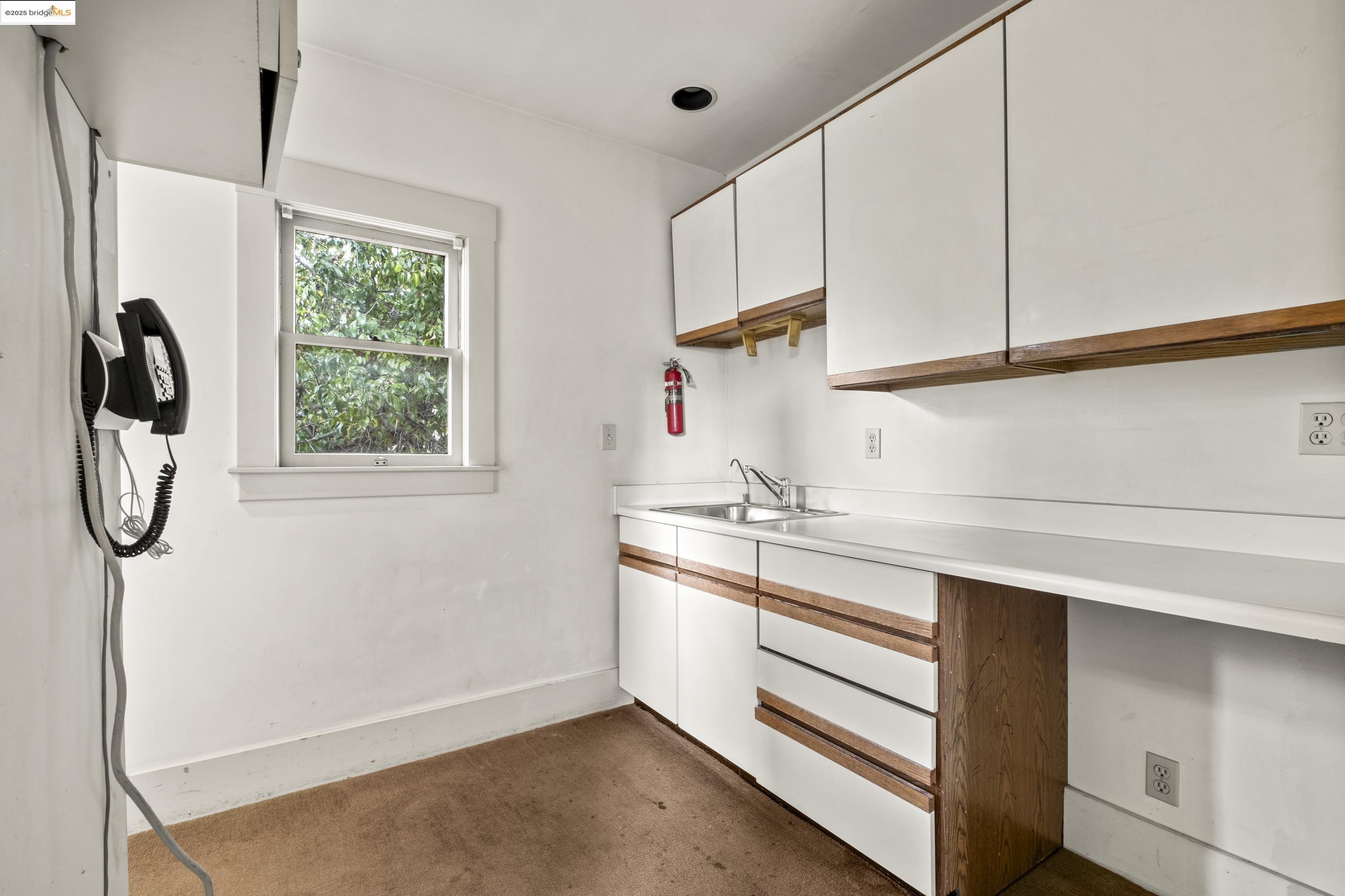 3050 Shattuck Avenue Berkeley, CA 94705 - Photo 28 of 41 a kitchen with a sink cabinets and a window