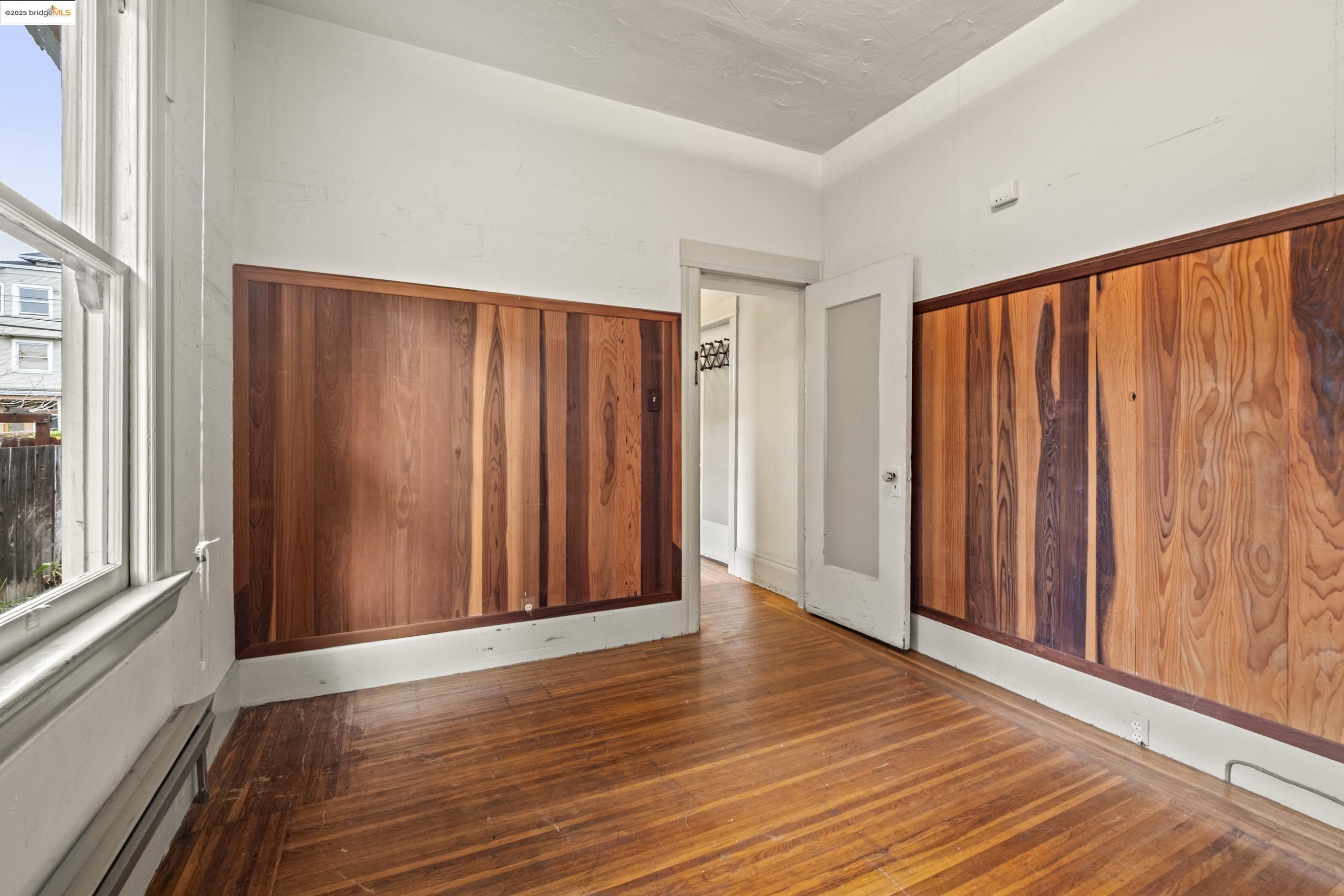3050 Shattuck Avenue Berkeley, CA 94705 - Photo 6 of 41 wooden floor in an empty room with a window