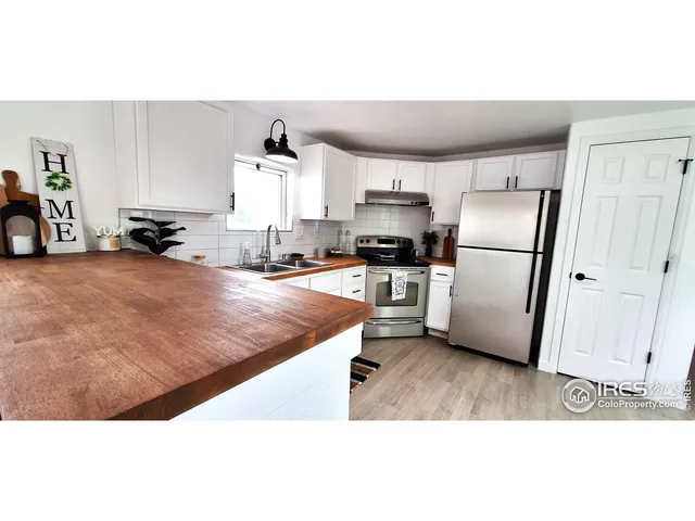a kitchen with stainless steel appliances a refrigerator and a stove top oven