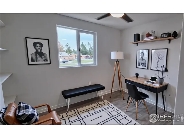 a living room with furniture and a painting on the wall