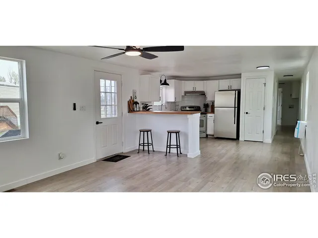 a open kitchen with cabinets and wooden floor