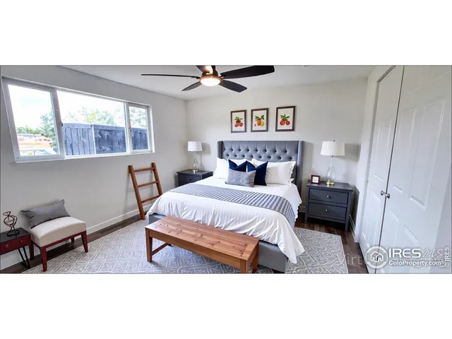 a bedroom with a bed a window and a chandelier