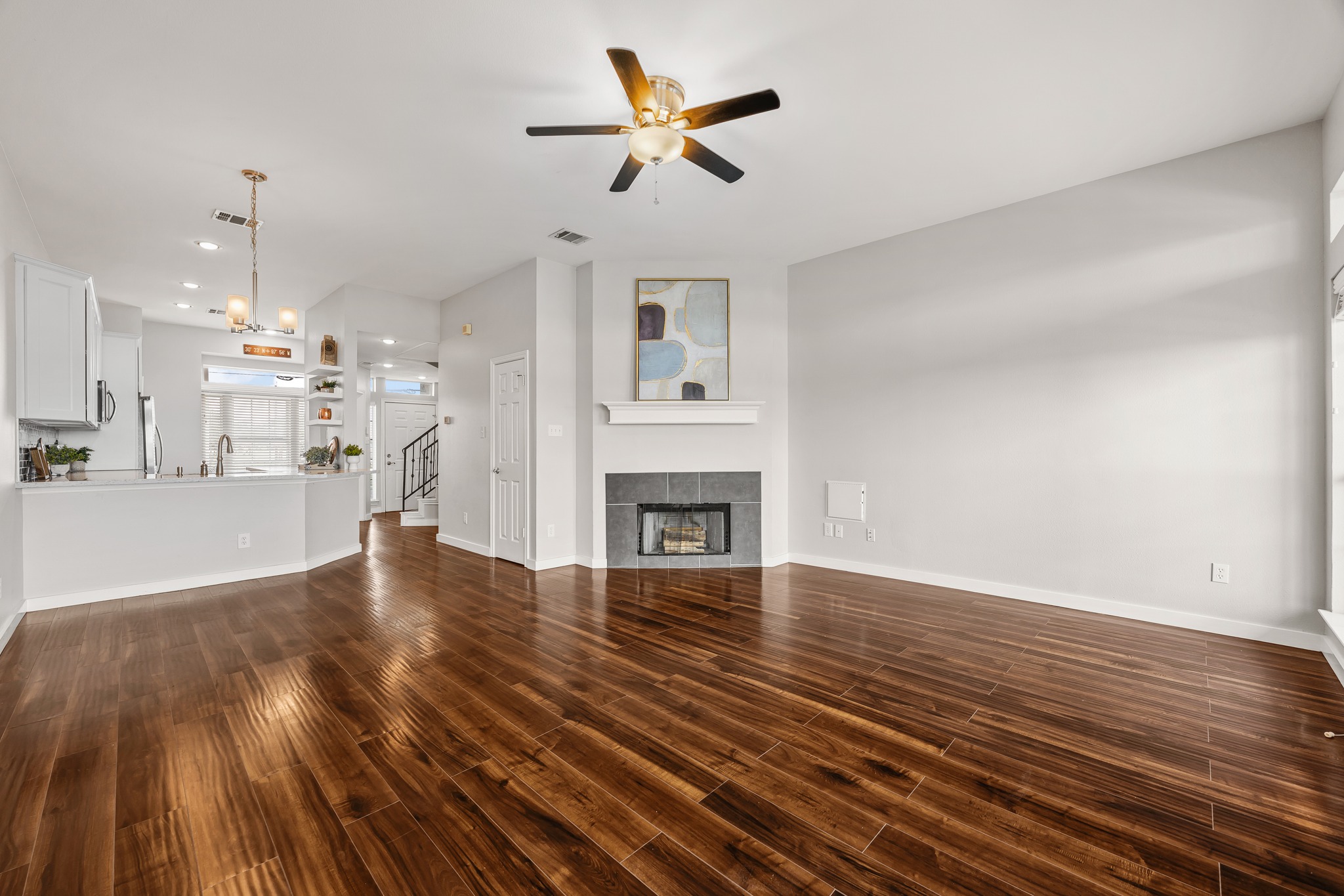 2918 Ranch Road 620 North, Unit S242 Austin, TX 78734 - Photo 13 of 35 Rich hardwood floors flow through this luminous space, complemented by a modern fireplace feature.