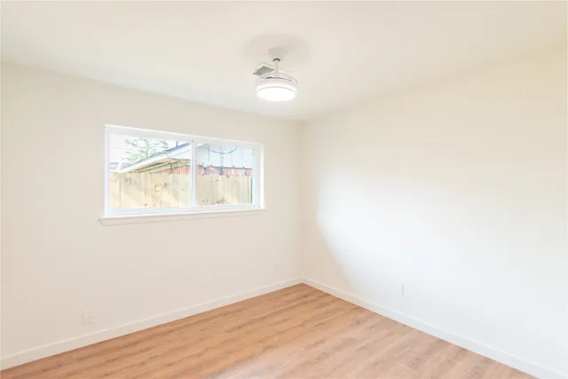 a view of a yard with wooden fence