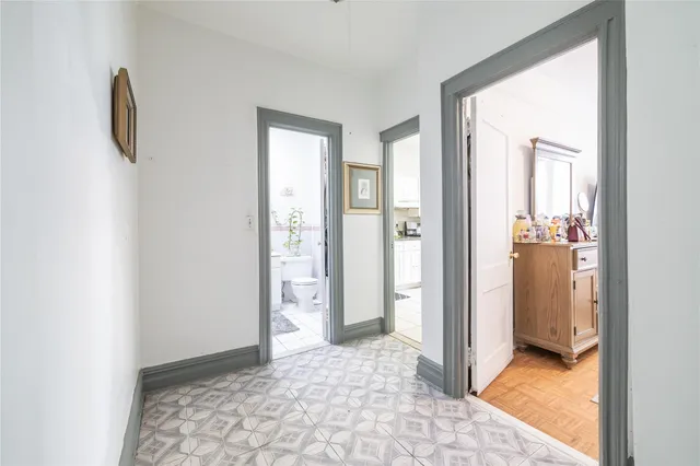 a kitchen with granite countertop a stove a sink and a refrigerator