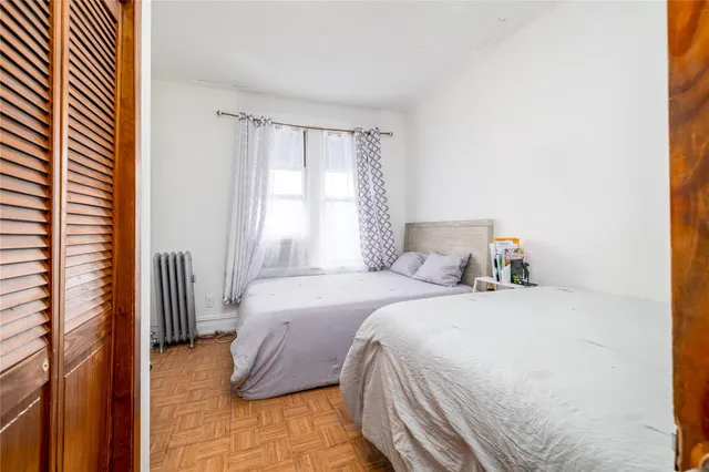a bed sitting in a bedroom next to a window