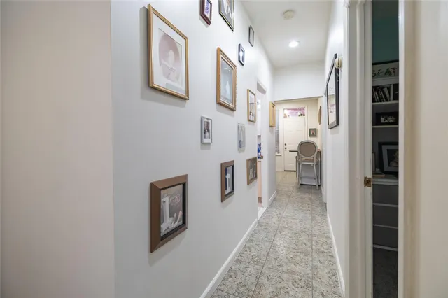 a hallway with painting on the wall