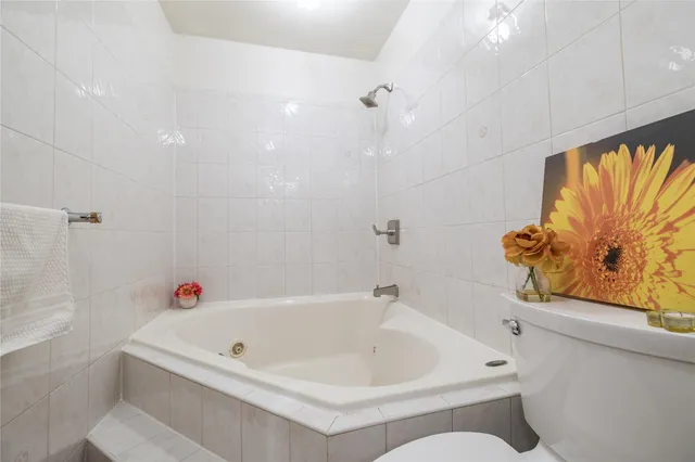 a white bath tub sitting next to a white sink