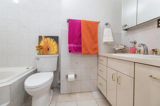 a bathroom with a sink toilet vanity and tub