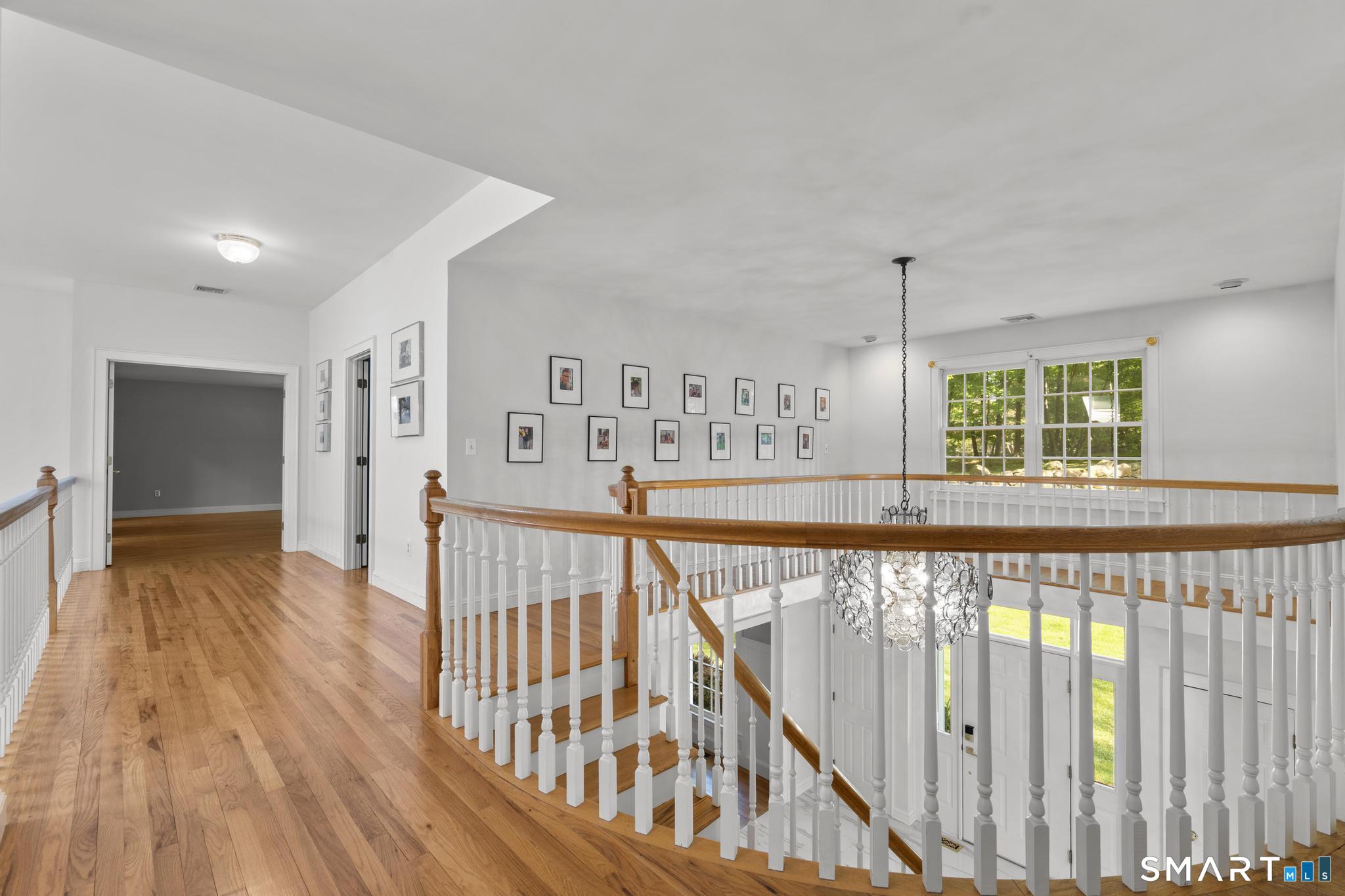 181 Old Branchville Road Ridgefield, CT 06877 - Photo 22 of 40 a view of a hallway with wooden floor stairs