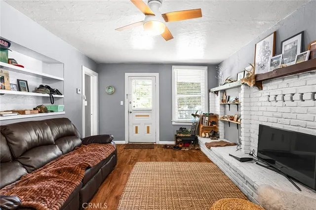 a kitchen with granite countertop a stove top oven a sink and dishwasher a refrigerator with white cabinets