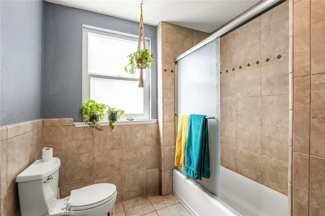 a bathroom with a sink mirror vanity and toilet