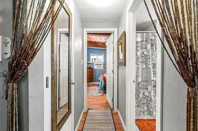 a living room with furniture a window and a flat screen tv