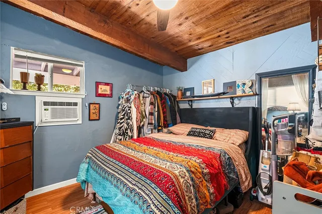 a living room with furniture kitchen view and a window