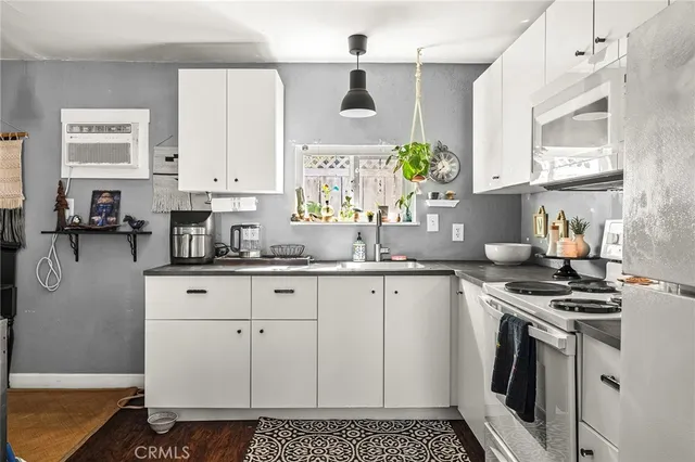 a view of a house with a yard and large tree