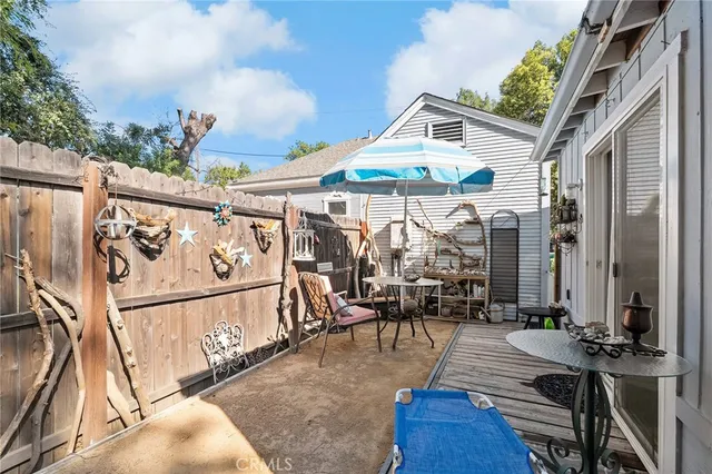 an aerial view of residential houses with outdoor space and trees all around