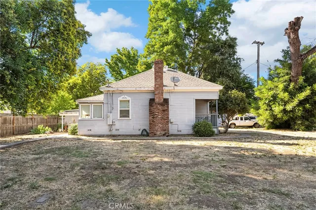 an aerial view of residential houses with outdoor space and trees