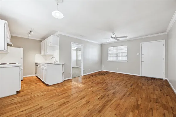 a view of a kitchen with wooden floor and a sink