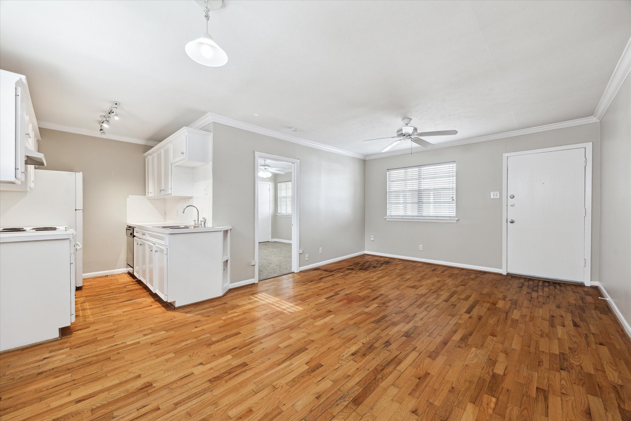 3618 Garrott Street, Unit 12 Houston, TX 77006 - Photo 2 of 13 a view of a kitchen with wooden floor and a sink