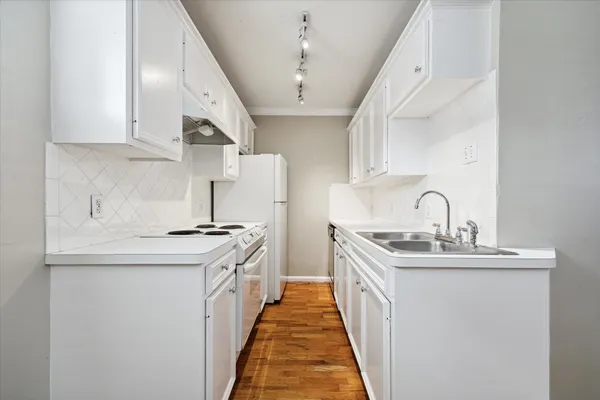 a kitchen with stainless steel appliances a sink stove and cabinets