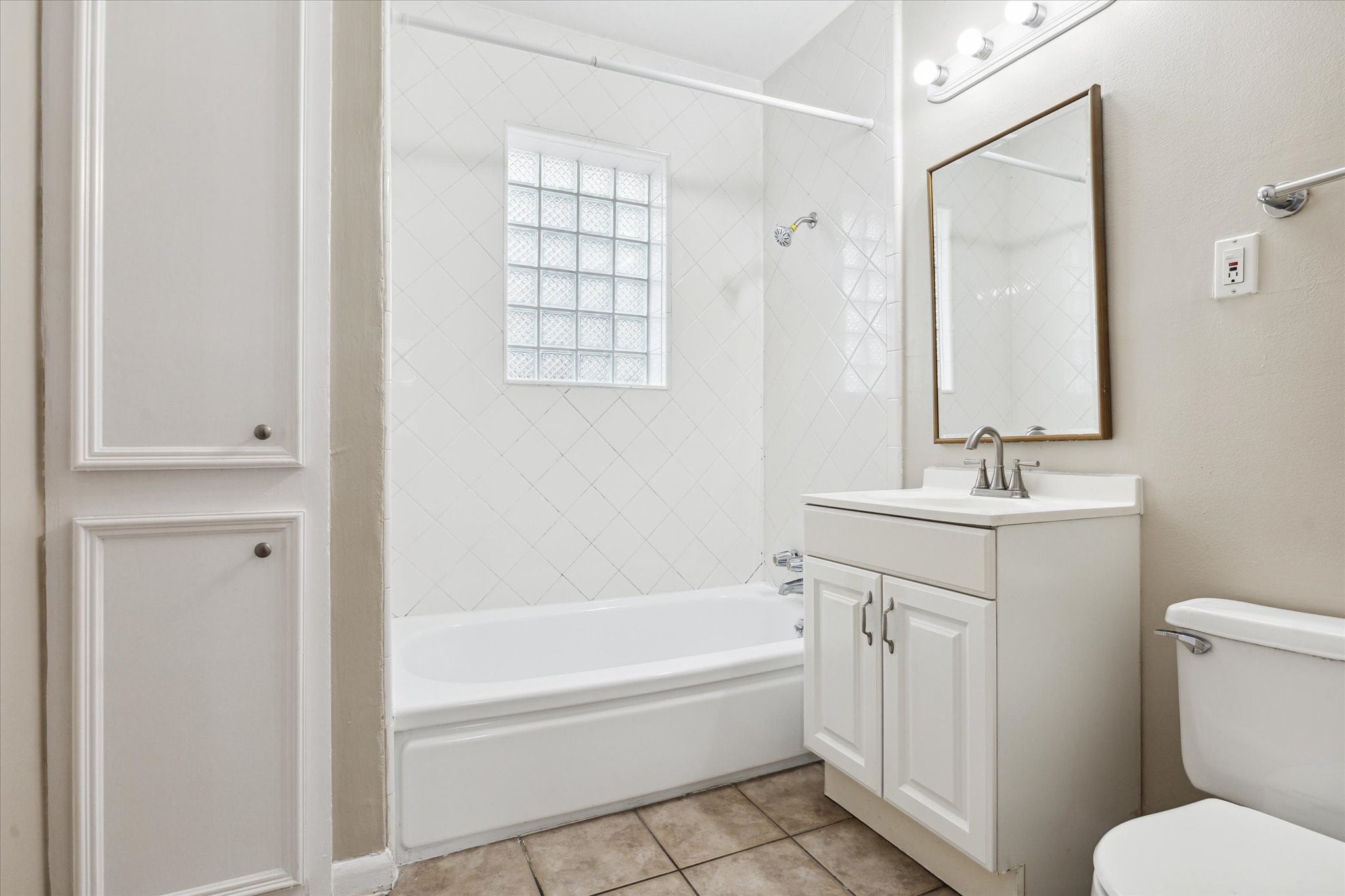 3618 Garrott Street, Unit 12 Houston, TX 77006 - Photo 10 of 13 a bathroom with a granite countertop sink a toilet and shower