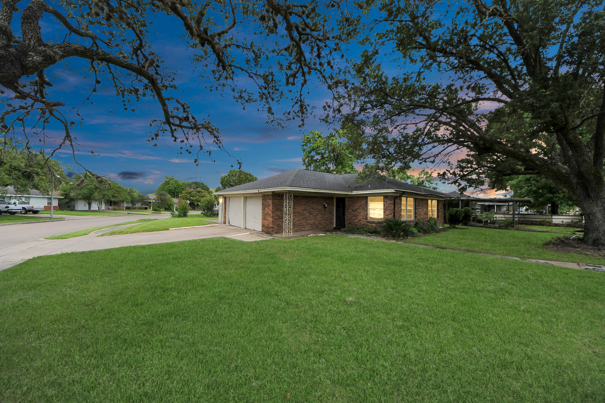 a view of a house with a yard and tree s