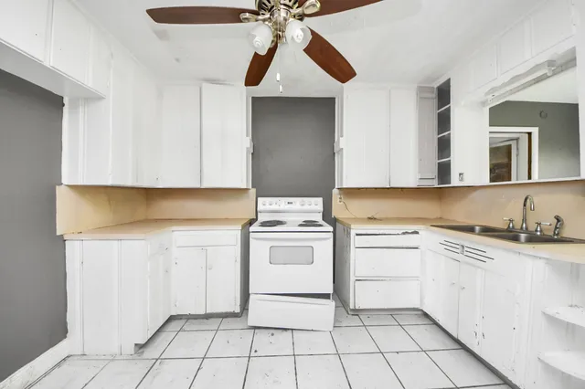 a kitchen with a stove sink and cabinets