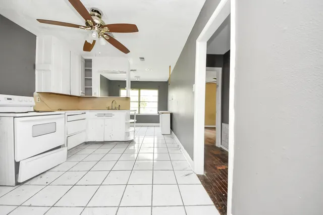 a view of a kitchen with wooden floor and electronic appliances