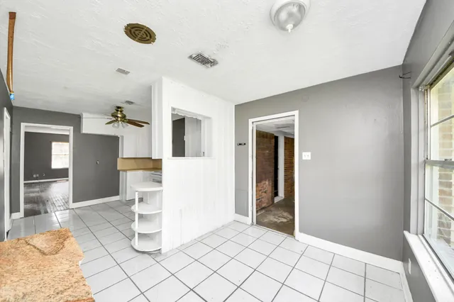 a view of a livingroom with wooden floor and a window