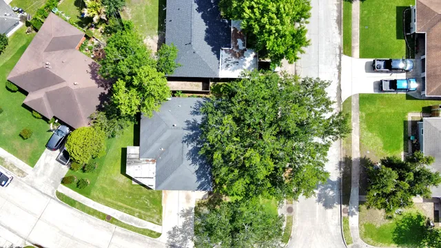 an aerial view of a house with garden space and swimming pool