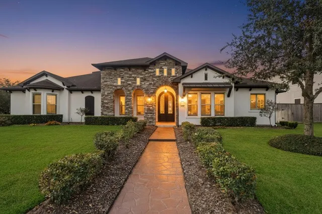 a front view of a house with a garden and yard