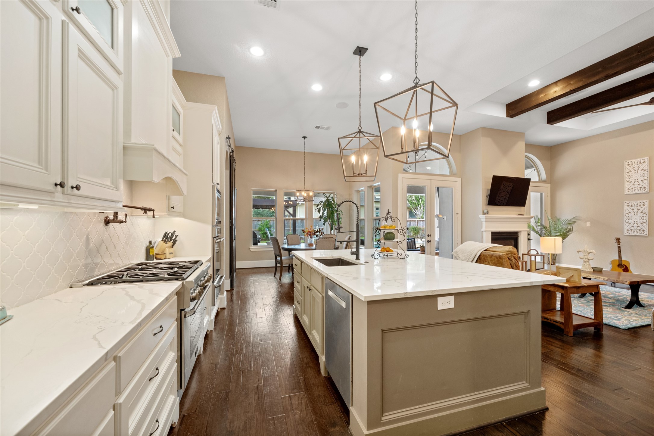 1702 Hunters Trail Friendswood, TX 77546 - Photo 15 of 42 a kitchen with stainless steel appliances a stove sink and cabinets