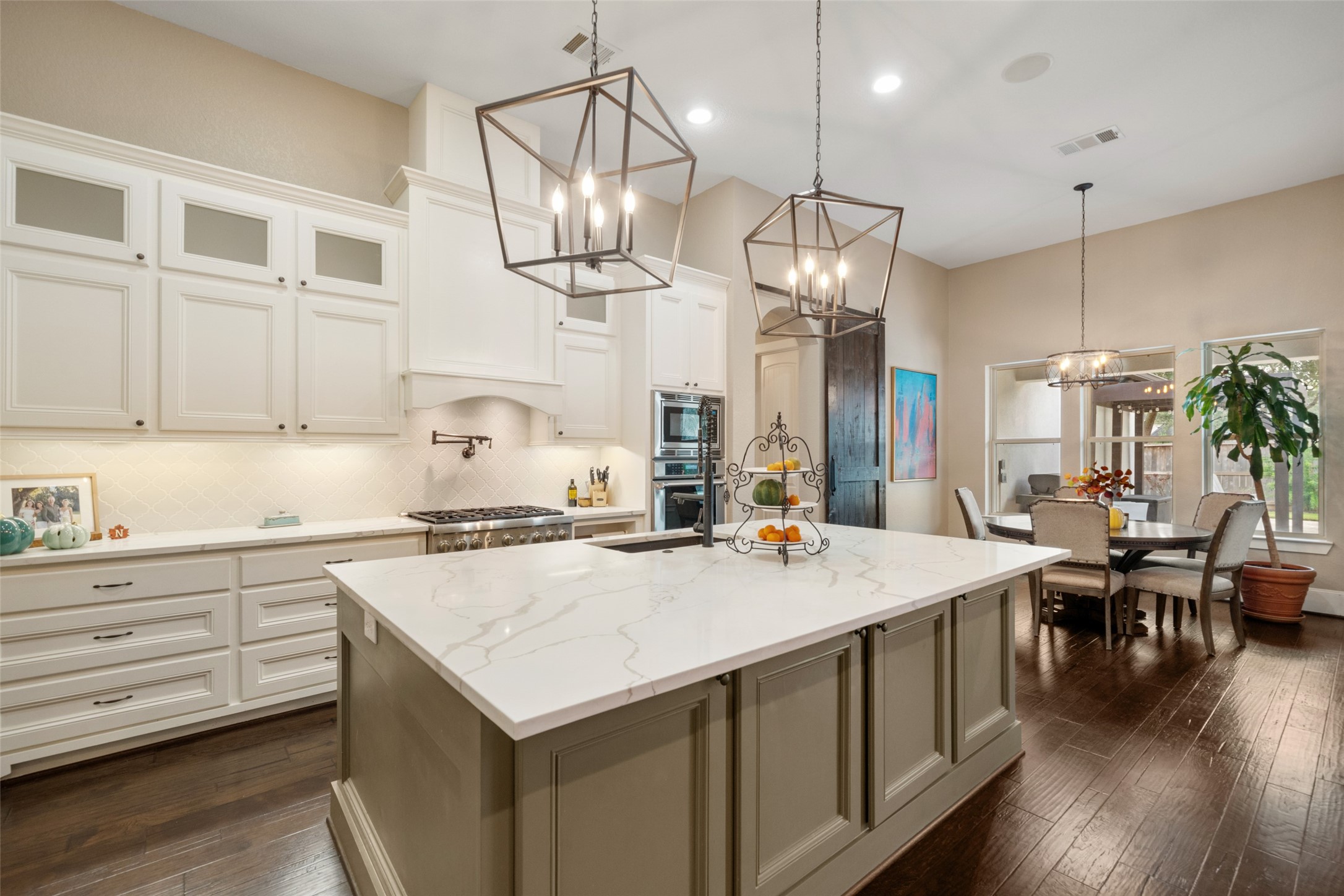 1702 Hunters Trail Friendswood, TX 77546 - Photo 16 of 42 a kitchen that has a lot of cabinets and wooden floor